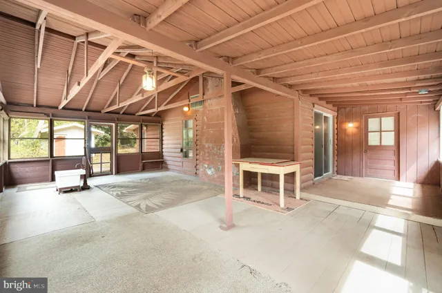 a spacious bedroom with a bed and a large window