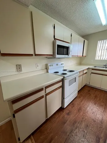 a kitchen with a sink cabinets and stainless steel appliances