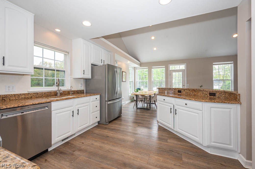6787 South Palmyra Road Canfield, OH 44406 - Photo 6 of 30 Kitchen featuring wood-finish flooring, white cabinetry, speckled countertops, stainless steel appliances, and recessed lighting
