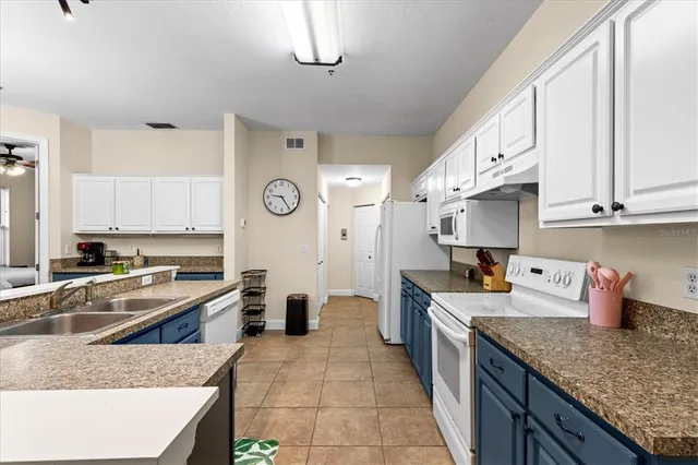 a kitchen with a sink a stove and cabinets