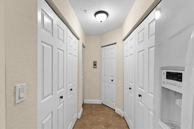 a view of a hallway with hallway with wooden floor and staircase