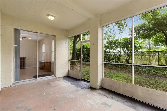 an empty room with floor to ceiling windows and an outdoor view