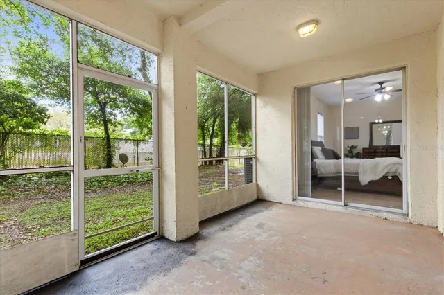 a view of a room with furniture and large windows