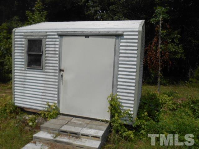 3837 Edgemont Road Wendell, NC 27591 - Photo 3 of 10 a view of a utility room with a small yard and plants