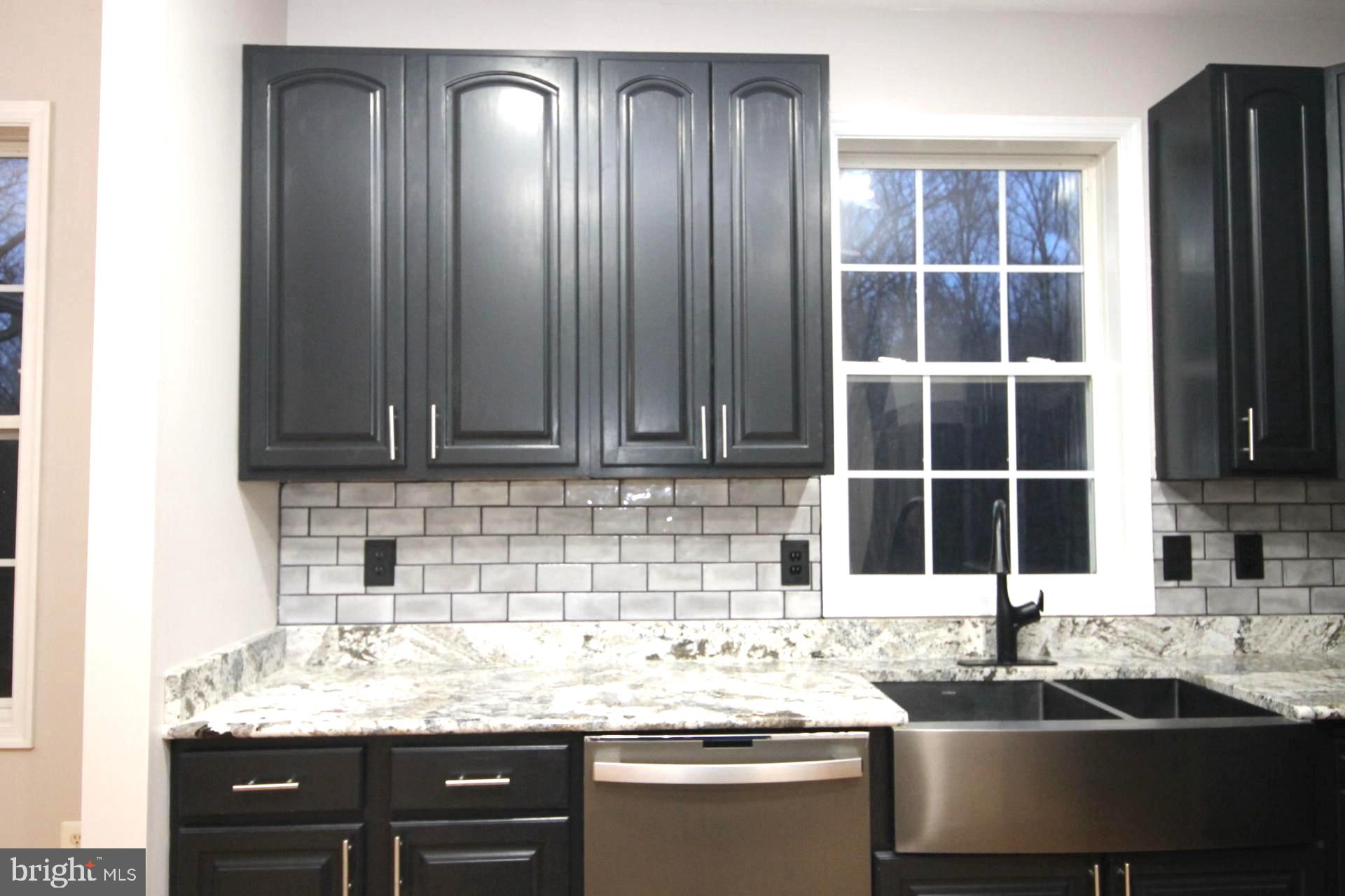 4695 Sands Road Harwood, MD 20776 - Photo 9 of 49 Sleek modern kitchen with dark cabinetry.