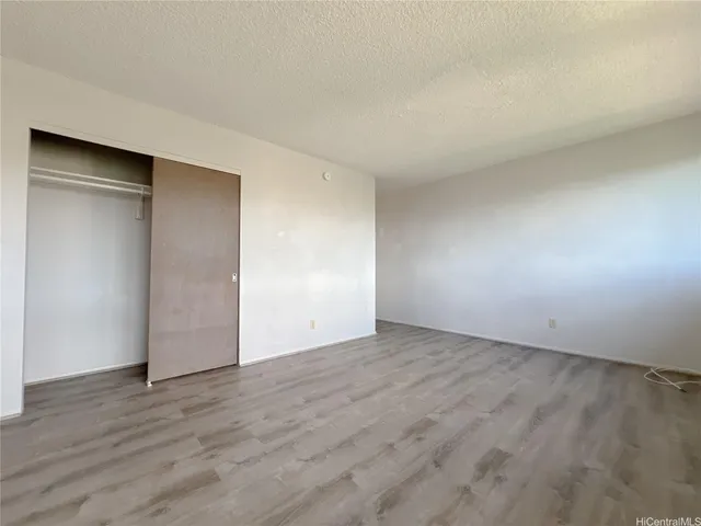 a view of an empty room and wooden floor