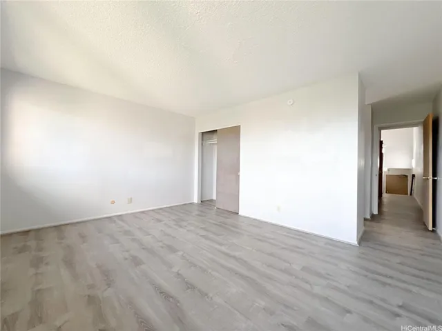 a view of an empty room and wooden floor