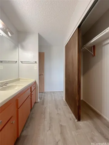 a spacious bathroom with a granite countertop sink and a mirror