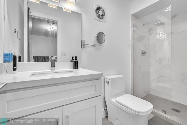 a bathroom with a double vanity sink a mirror and a bathtub