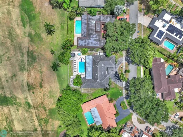 an aerial view of a house with a yard