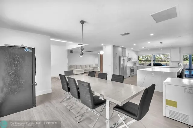 a large white kitchen with lots of counter space and a sink