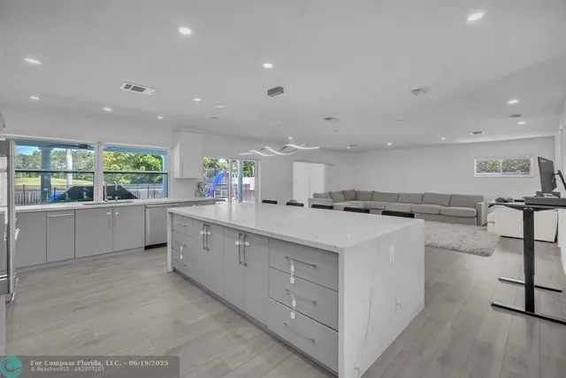 a kitchen with a sink and a large window