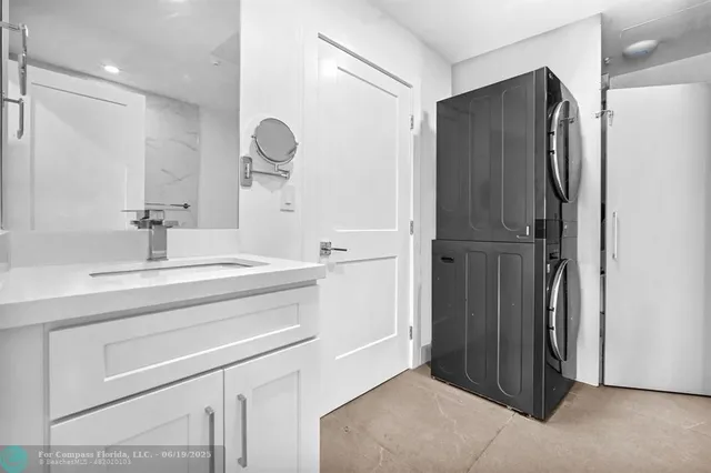 a bathroom with a shower sink and mirror