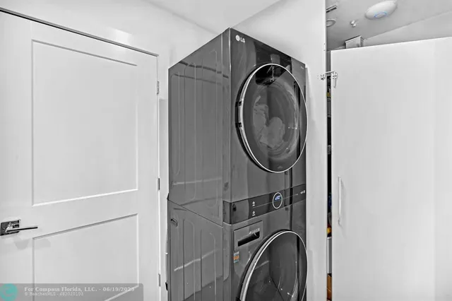 a view of a patio with a dining table and chairs under an umbrella