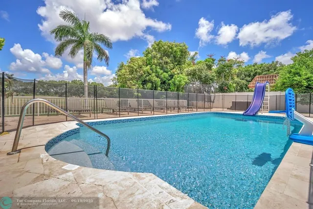a view of a house with a tree and plants