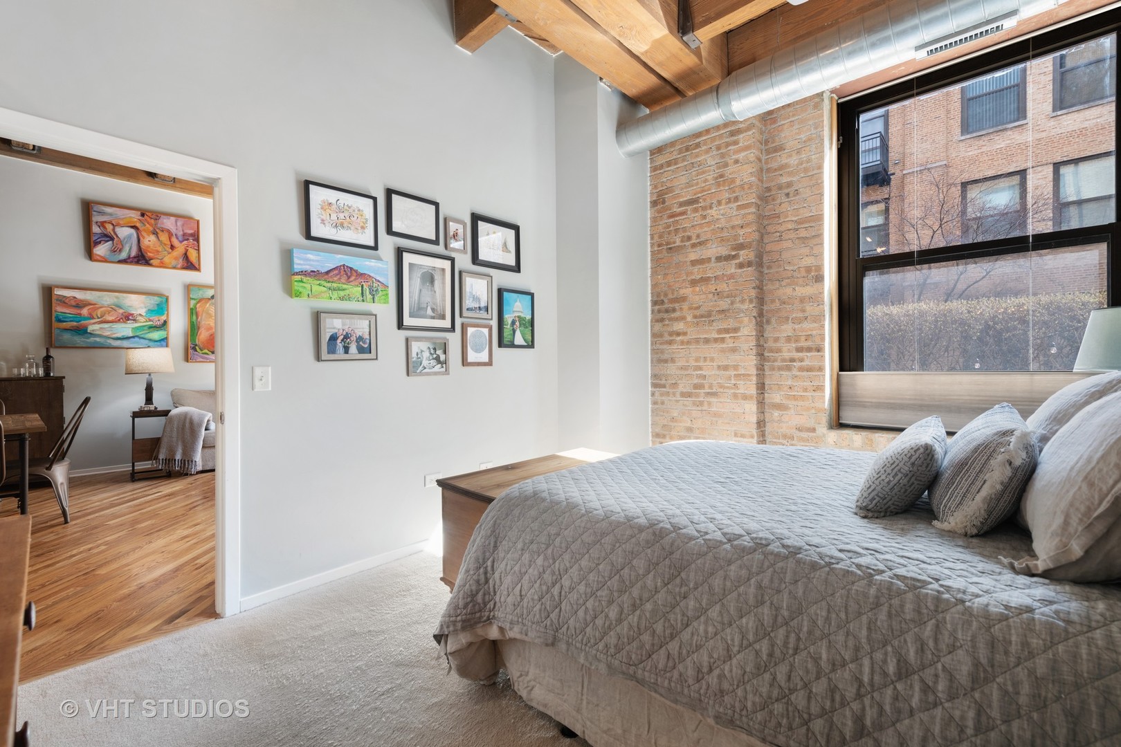 1040 West Adams Street, Unit 248 Chicago, IL 60607 - Photo 11 of 19 a bedroom with a bed and wooden floor