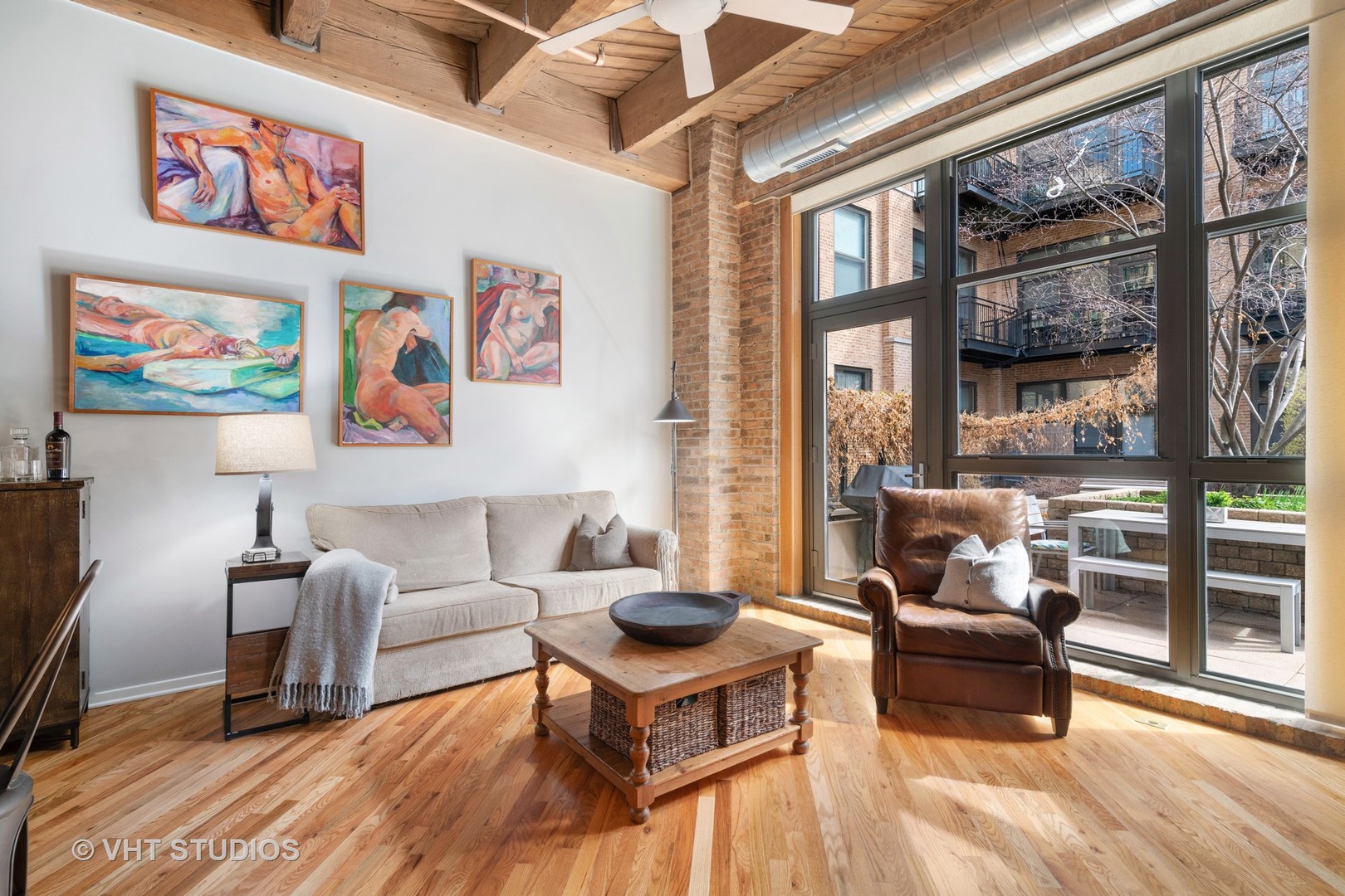 1040 West Adams Street, Unit 248 Chicago, IL 60607 - Photo 5 of 19 a living room with furniture a flat screen tv and a floor to ceiling window