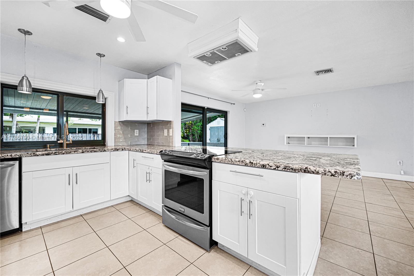8451 Northwest 10th Street Pembroke Pines, FL 33024 - Photo 11 of 32 a kitchen with granite countertop cabinets a sink and appliances