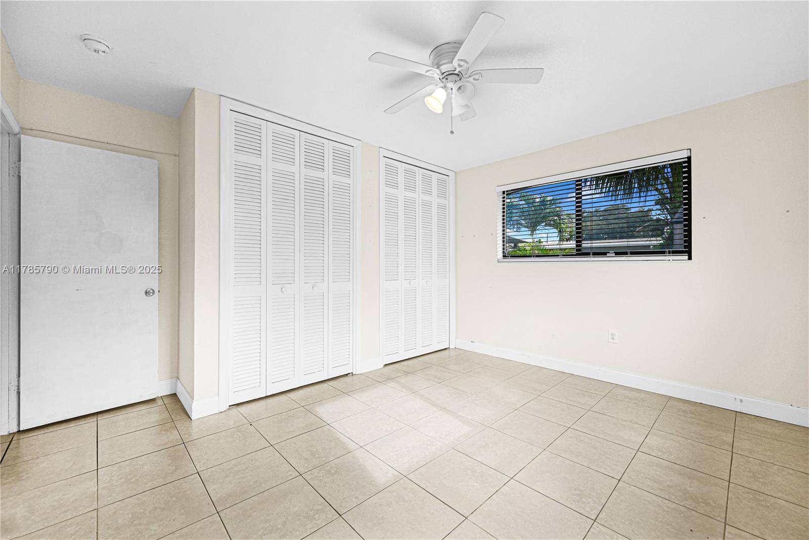 8451 Northwest 10th Street Pembroke Pines, FL 33024 - Photo 13 of 32 a view of an empty room with window