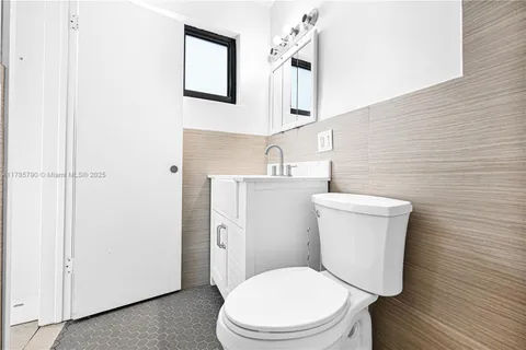a white toilet sitting next to a bathroom sink