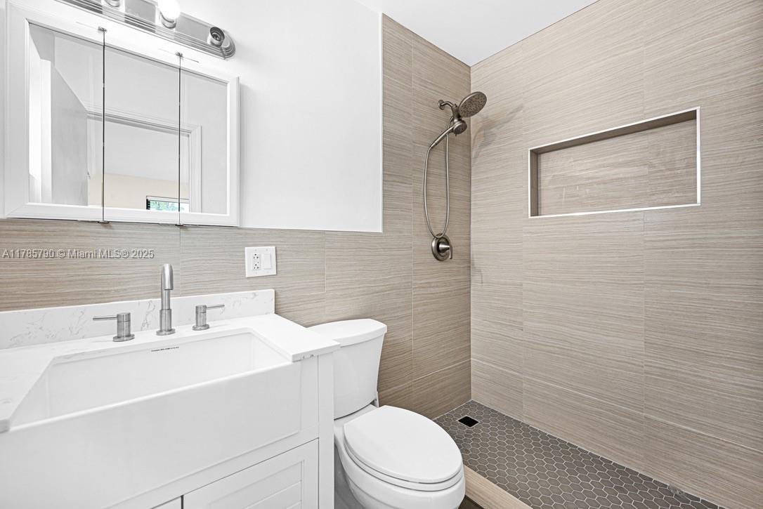 8451 Northwest 10th Street Pembroke Pines, FL 33024 - Photo 17 of 32 a bathroom with a sink a toilet and shower