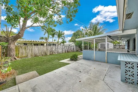 a view of backyard with a garden and deck