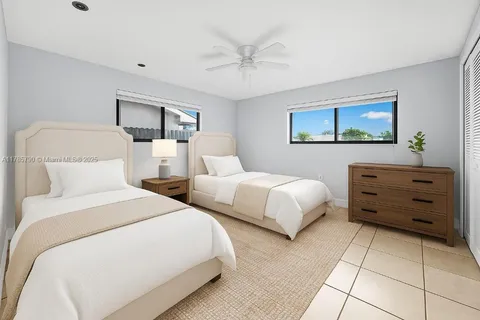 a bedroom with a bed and a ceiling fan