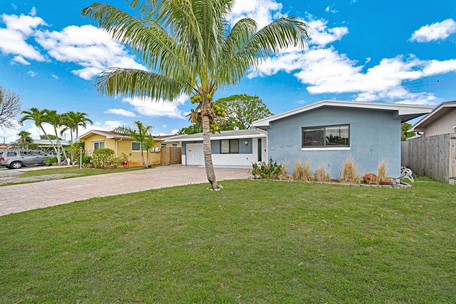 8451 Northwest 10th Street Pembroke Pines, FL 33024 - Photo 5 of 32 a house with a garden in front of it