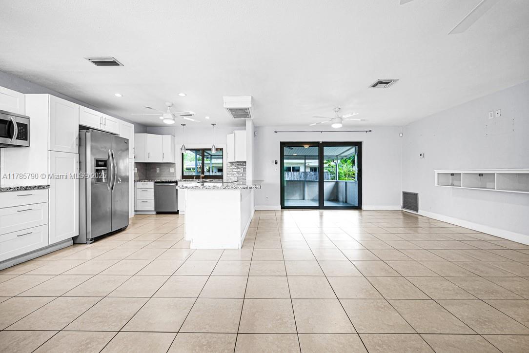 8451 Northwest 10th Street Pembroke Pines, FL 33024 - Photo 7 of 32 a kitchen with stainless steel appliances a refrigerator sink and cabinets
