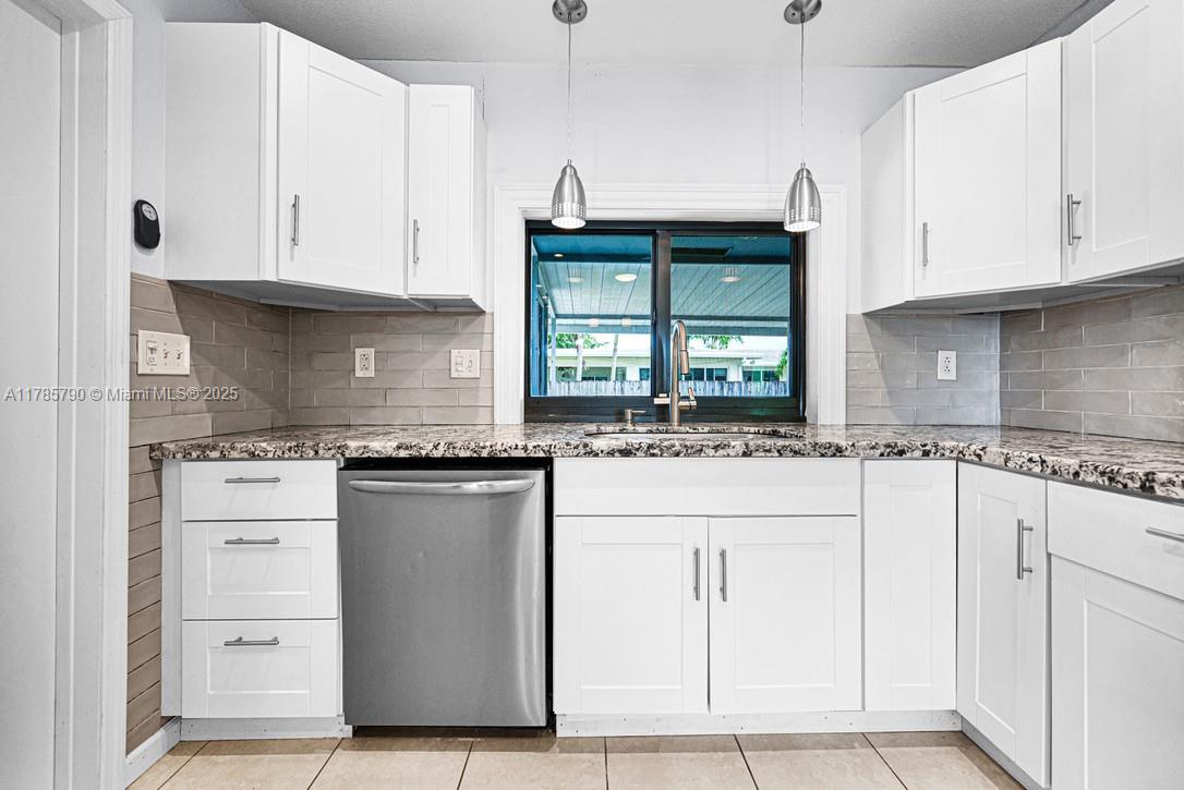 8451 Northwest 10th Street Pembroke Pines, FL 33024 - Photo 10 of 32 a kitchen with granite countertop white cabinets and a stainless steel appliances