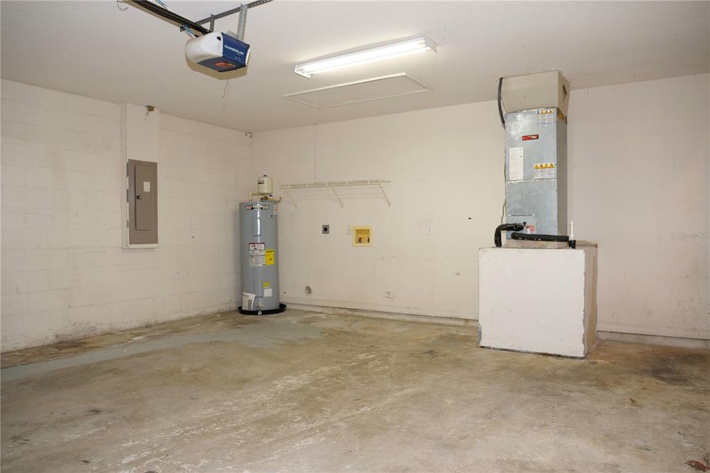 an empty room with ceiling fan and window
