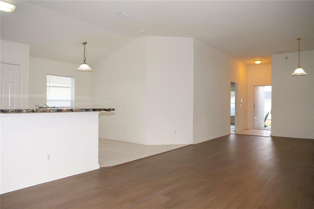 415 Danube Way Kissimmee, FL 34759 - Photo 11 of 17 an empty room with wooden floor and windows