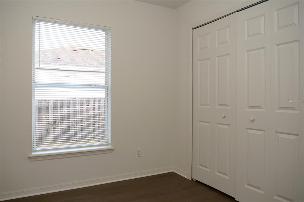 415 Danube Way Kissimmee, FL 34759 - Photo 15 of 17 an empty room with a window and wooden door