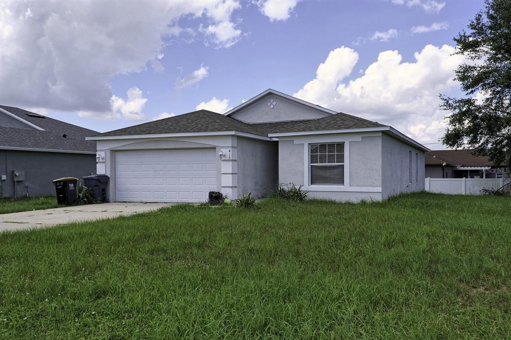 415 Danube Way Kissimmee, FL 34759 - Photo 3 of 17 a front view of a house with a garden