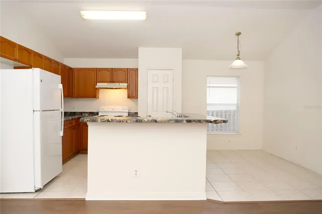 a kitchen with refrigerator and window