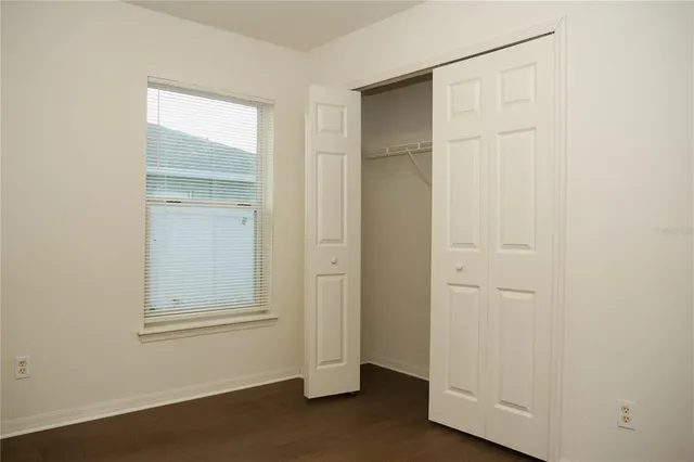 an empty room with closet area