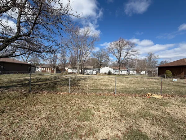 a view of yard covered with snow in front of house