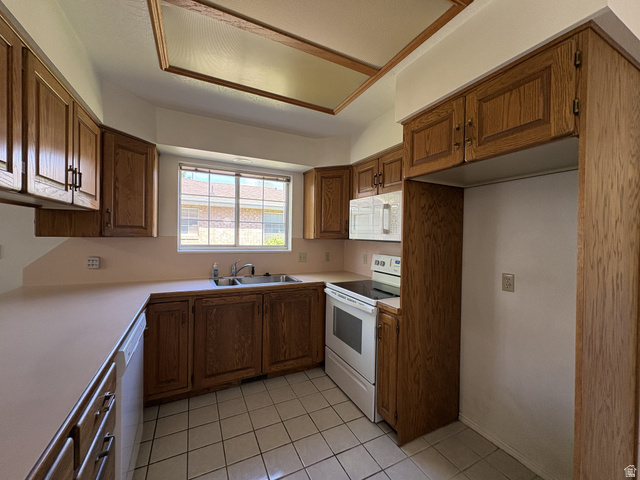 486 West 120 North Orem, UT 84057 - Photo 9 of 30 Kitchen with wood-finish cabinetry, solid surface countertops, and white tile flooring
