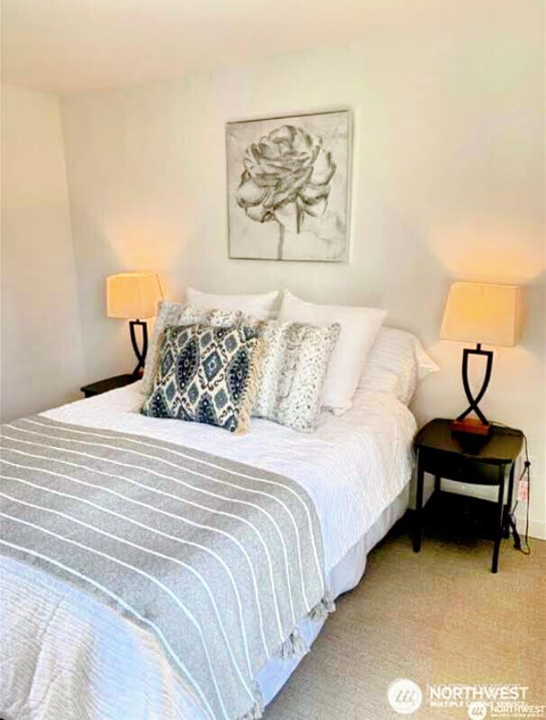 604 Northwest 77th Street, Unit D Seattle, WA 98117 - Photo 7 of 11 a bedroom with a bed and painting on the wall