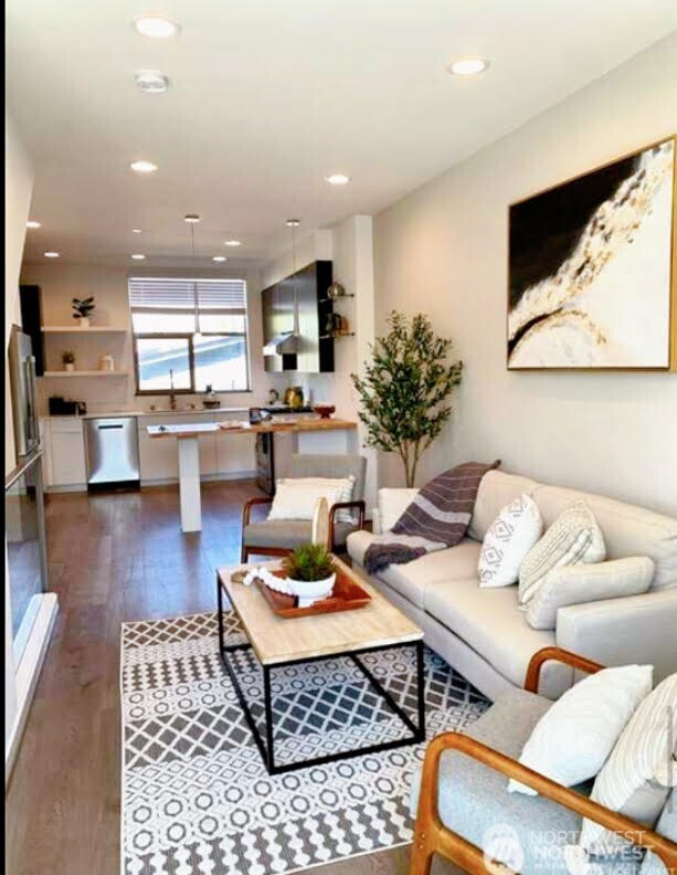 604 Northwest 77th Street, Unit D Seattle, WA 98117 - Photo 10 of 11 a living room with furniture and a wooden floor