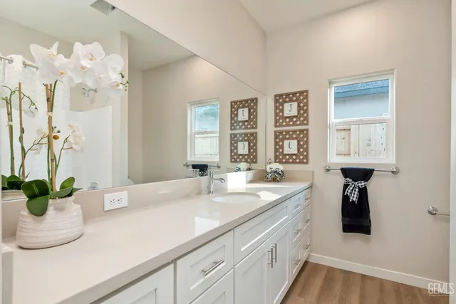 a bedroom with a bed and painting on the wall