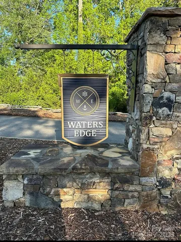 a view of entrance gate of a house and trees