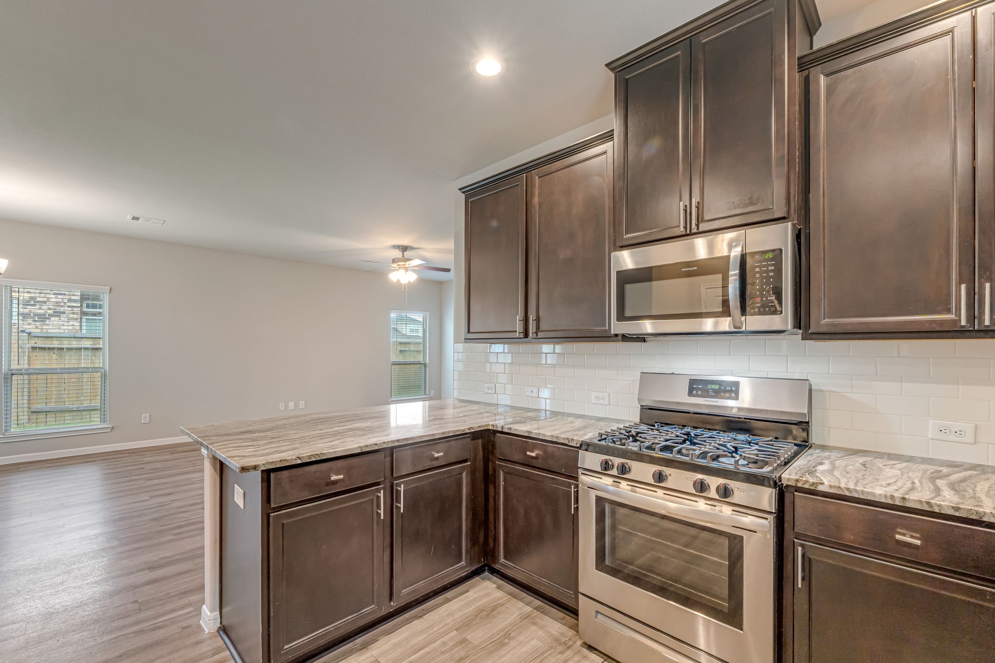 10314 Birch Peak Drive Rosharon, TX 77583 - Photo 13 of 38 a kitchen with cabinets stainless steel appliances and wooden floor