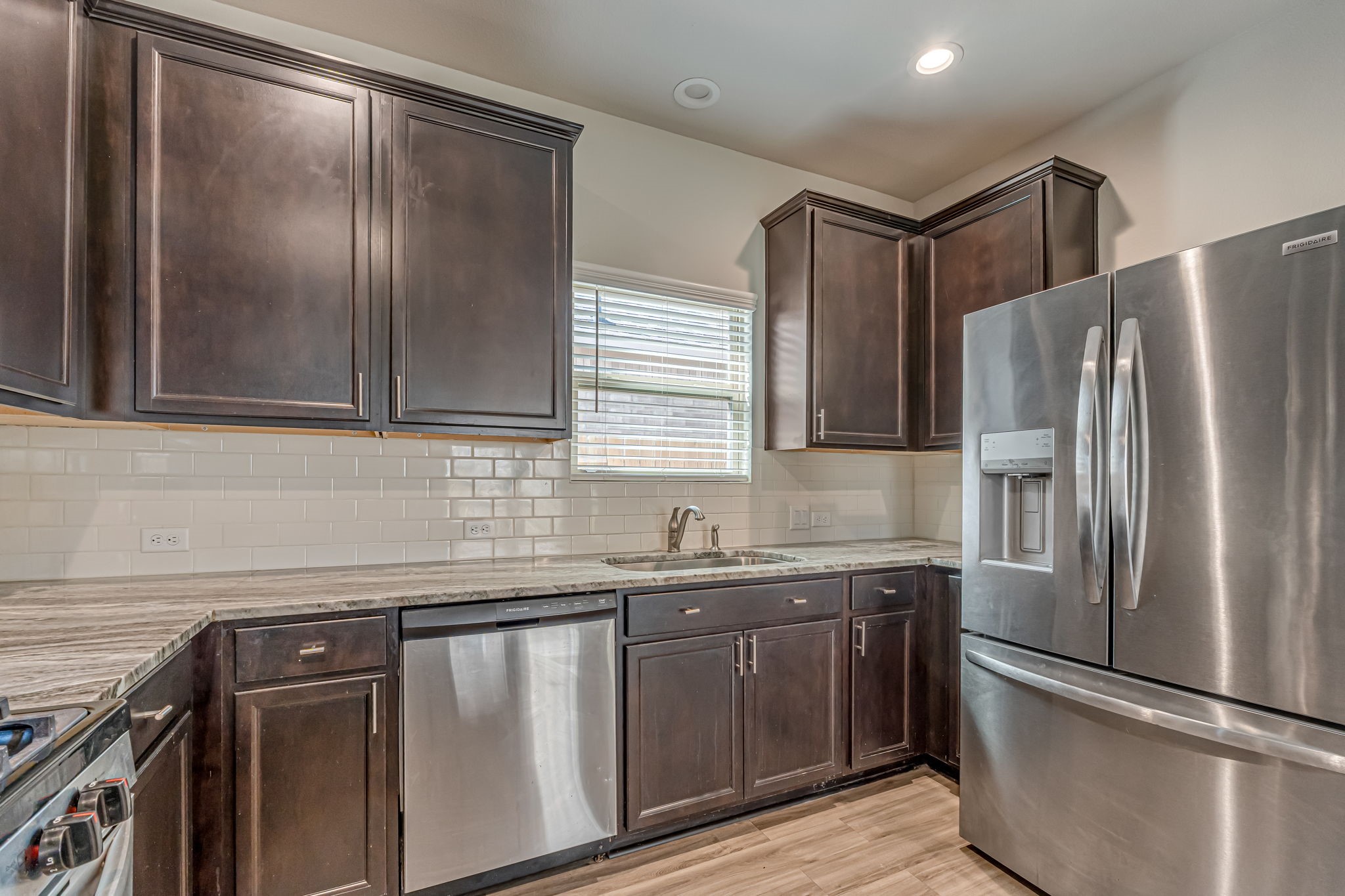 10314 Birch Peak Drive Rosharon, TX 77583 - Photo 15 of 38 a kitchen with stainless steel appliances granite countertop a refrigerator and a sink
