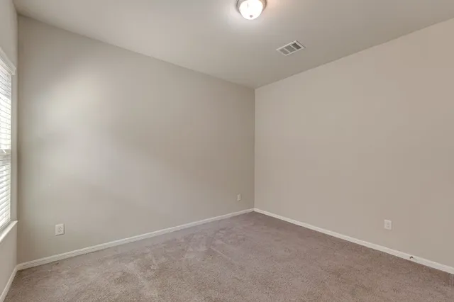 an empty room with a empty space and window