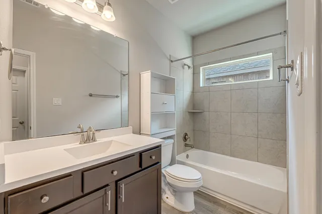 a bathroom with a sink a toilet and bathtub