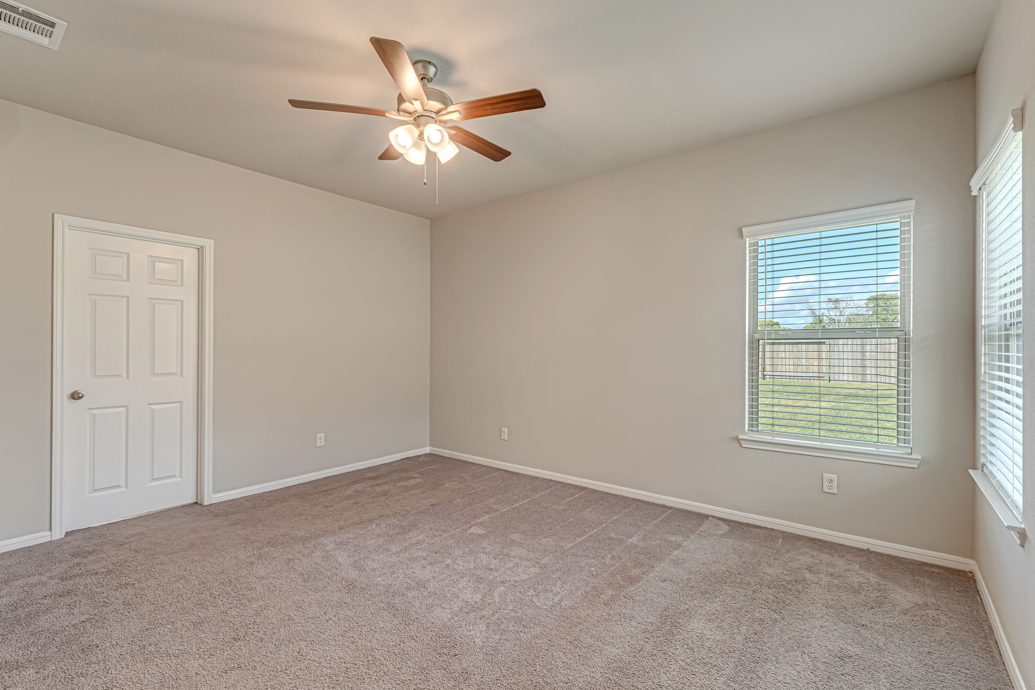 10314 Birch Peak Drive Rosharon, TX 77583 - Photo 21 of 38 an empty room with chandelier fan and windows