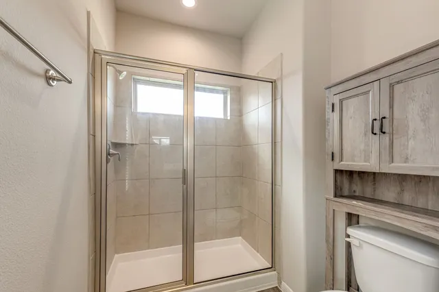 a bathroom with a shower and a sink