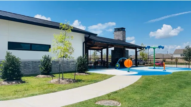 a view of a house with backyard and porch
