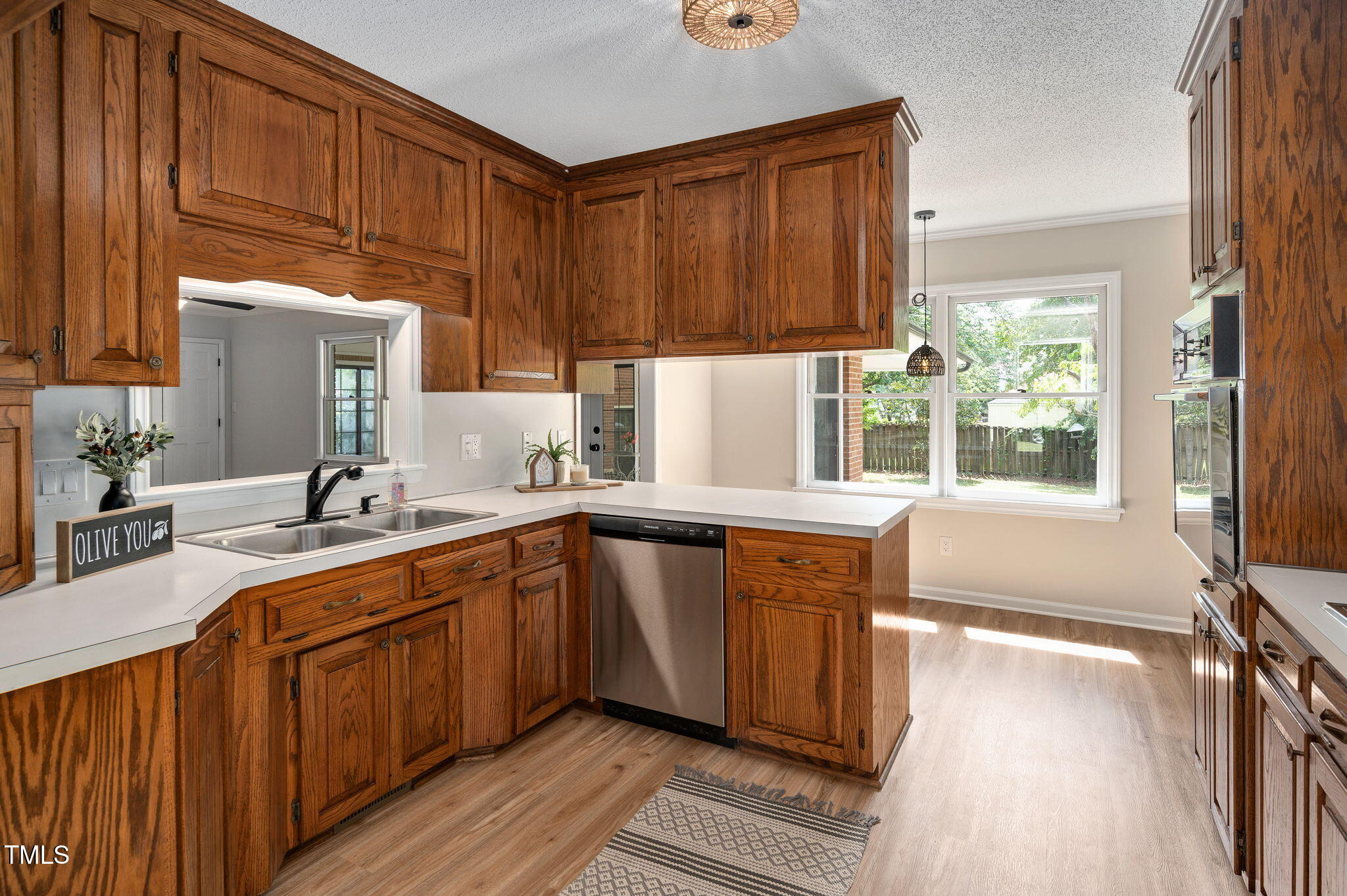 603 Warren Road Erwin, NC 28339 - Photo 12 of 38 a kitchen with stainless steel appliances granite countertop wooden cabinets a sink and dishwasher a oven with wooden floor